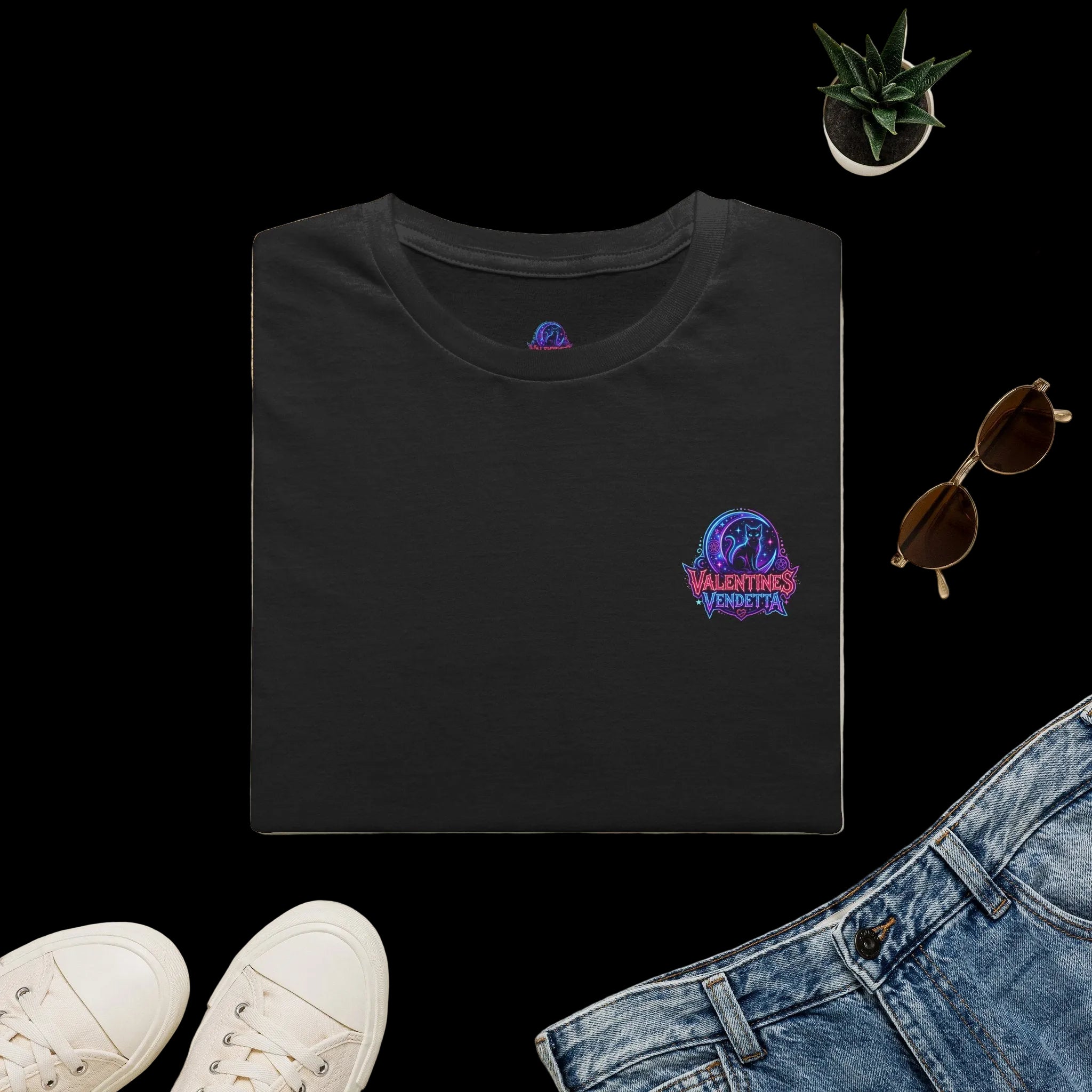 Navy blue t-shirt with 'CV27' logo on a light surface with accessories like a hat, sunglasses, and shoes.